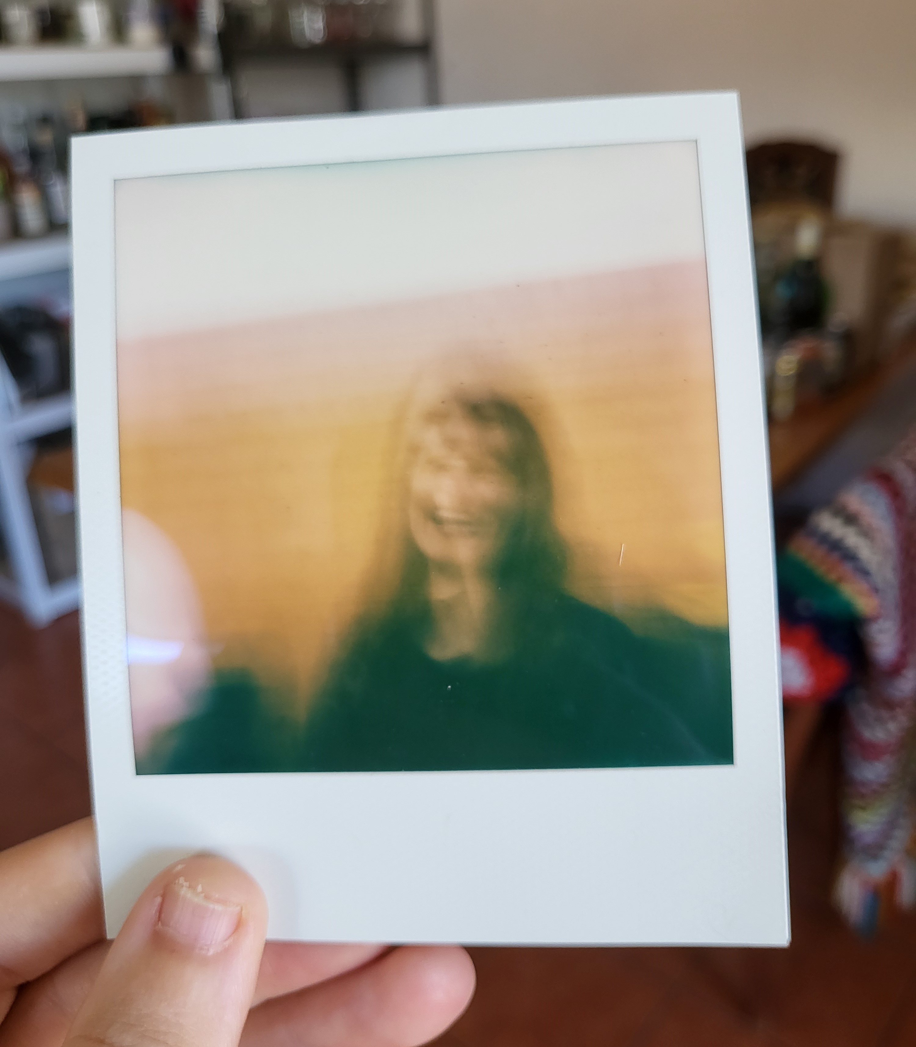 polaroid print out of blurry, smiling face